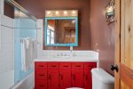 Colorful bathroom with shower/ tub combo